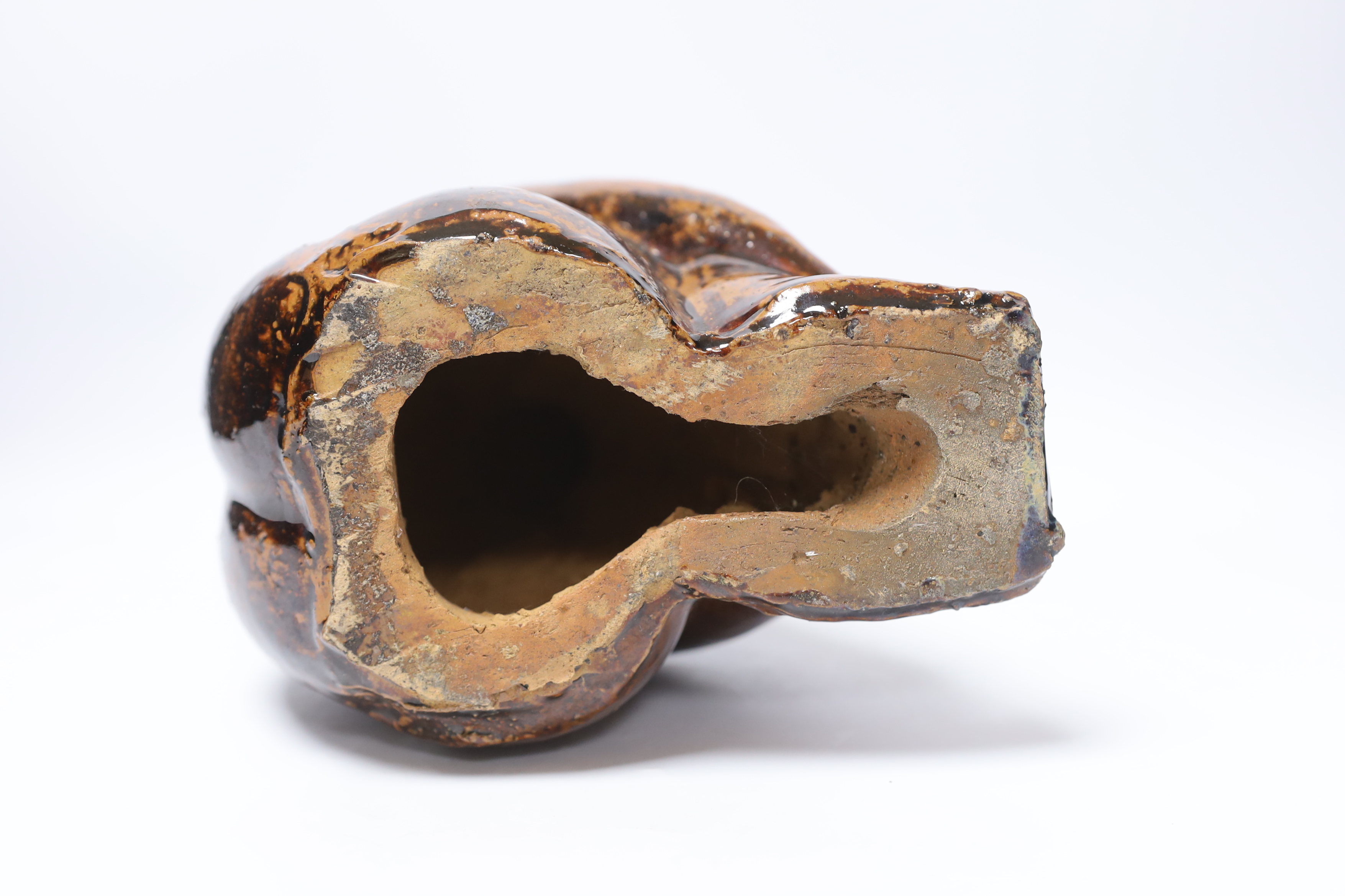 A 20th century tenmoko glazed pottery figure of a seated figure, 22cm